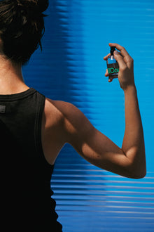A woman spraying fragrance 
