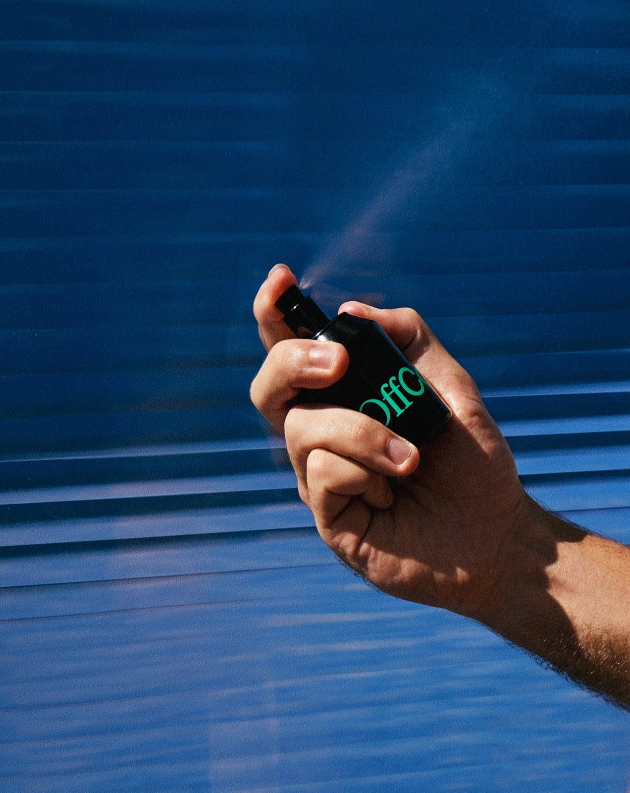 Man spraying the fragrance