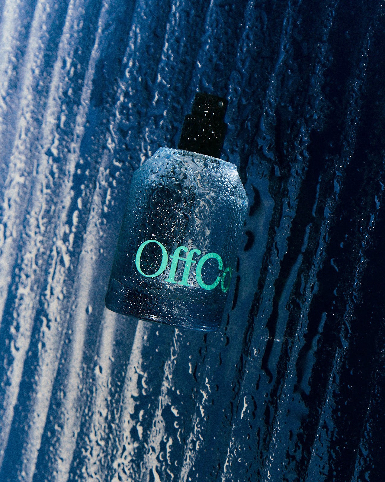 Fragrance bottle laying on a glass