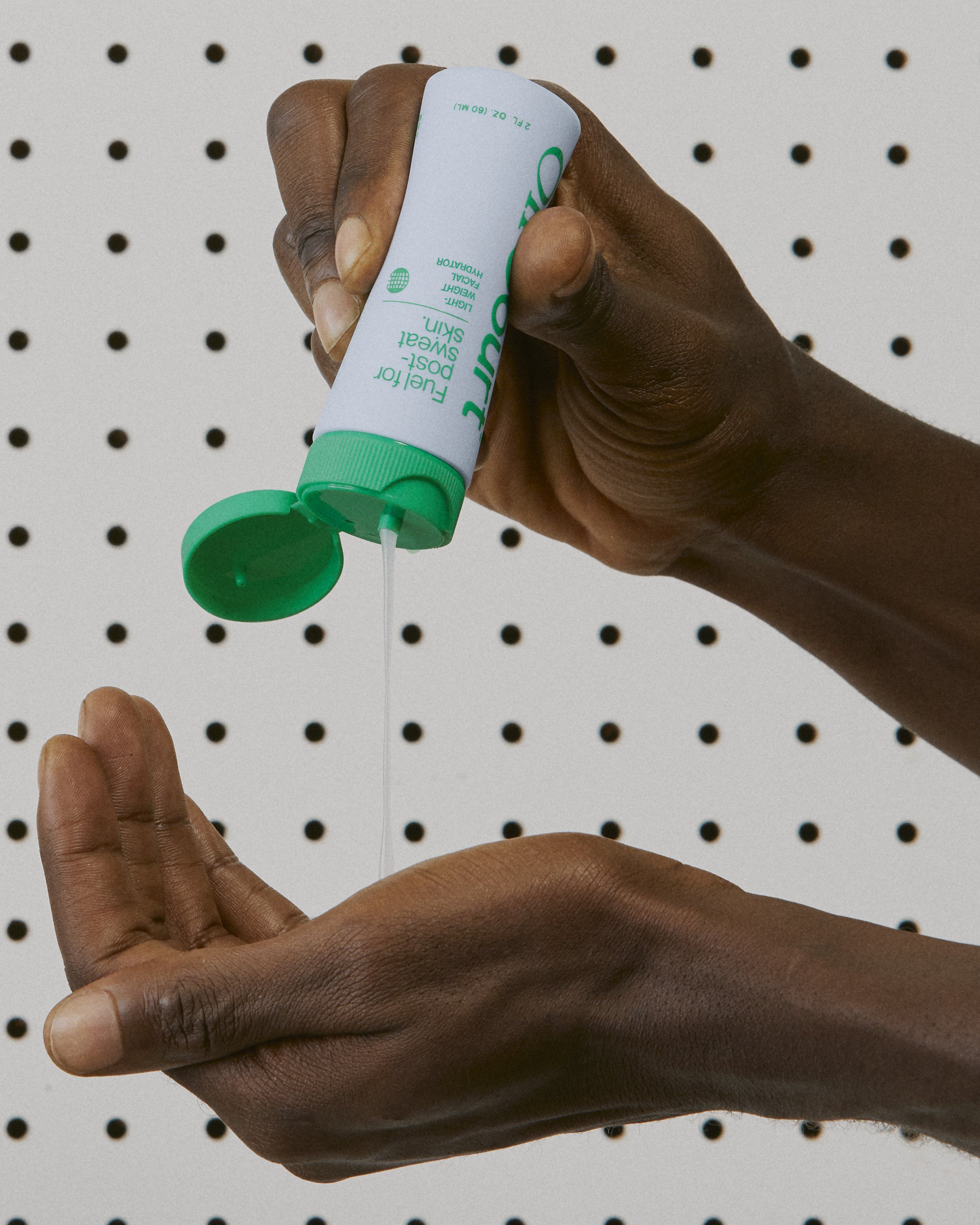 Facial Hydrator coming out of the bottle and pouring into the hand