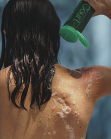 A woman using the body wash in shower