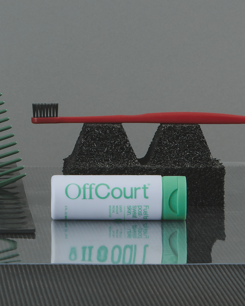 Facial Hydrator laid on a surface beside a toothbrush